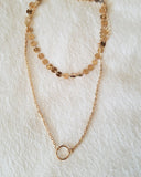Gold layered disc choker with a karma pendant layered necklace