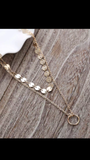 Gold layered disc choker with a karma pendant layered necklace